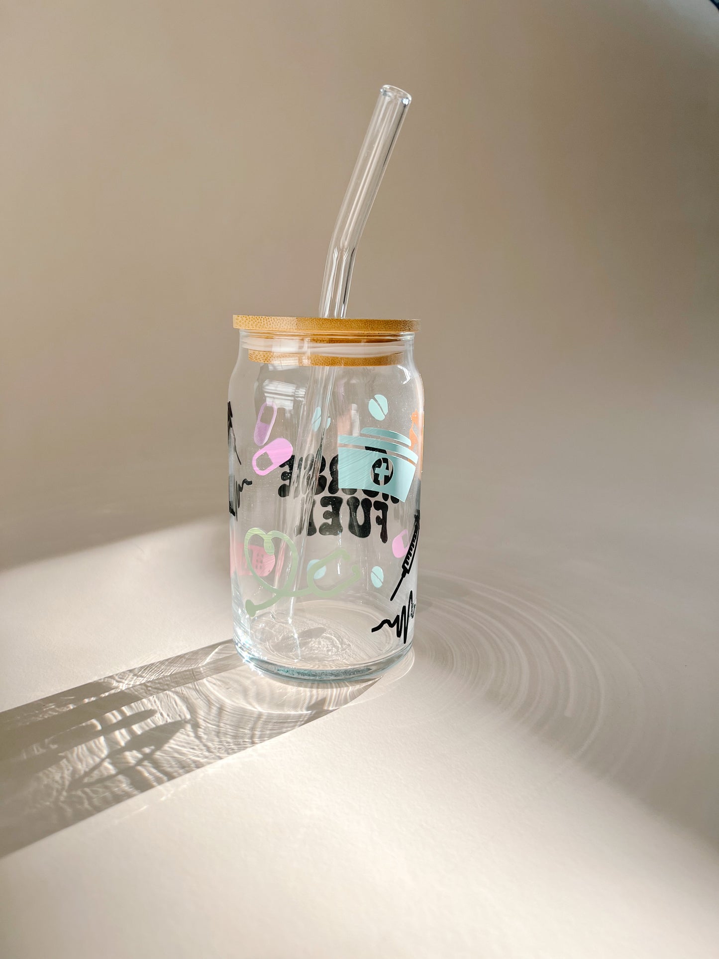back view of nurses fuel cup with pills stethoscope and nurses hat