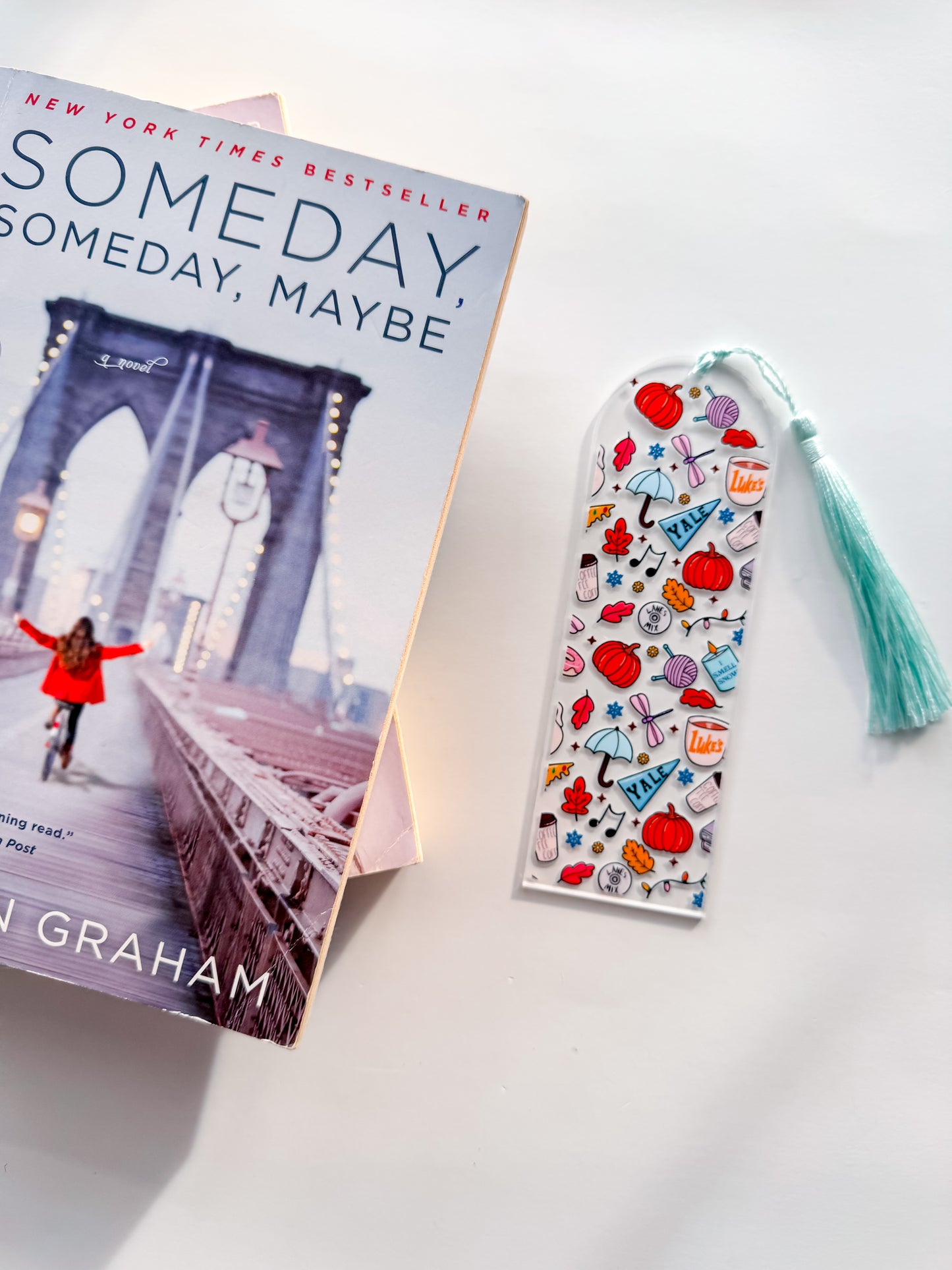 Book titled 'Someday, Maybe' by Jen Graham with a colorful bookmark on a light background
