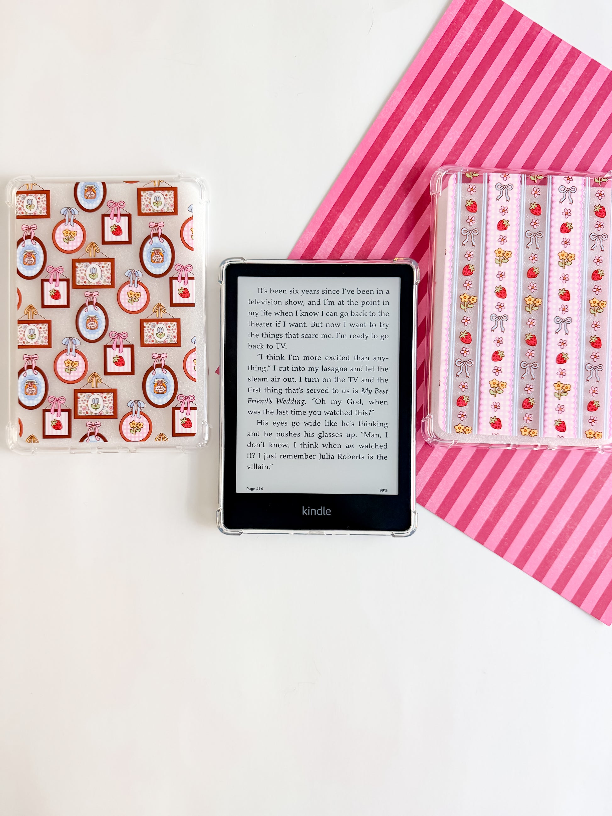 Kindle device with decorative cases on a white background